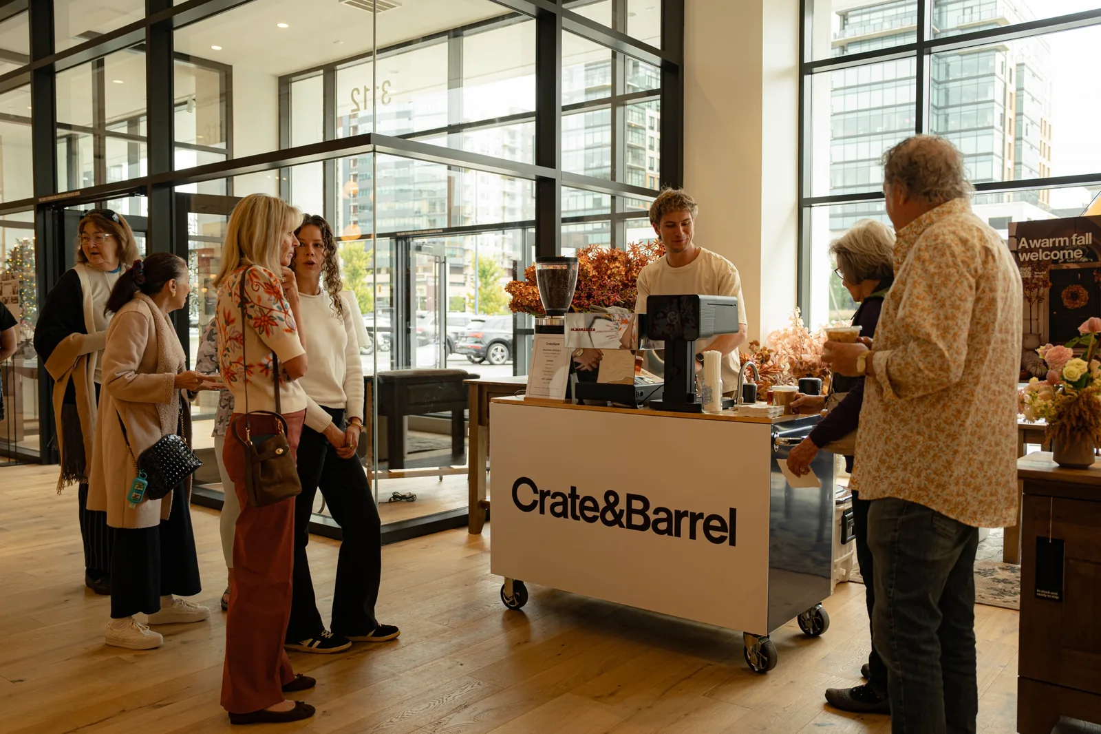The Zado cart wrapped in Crate and Barrel branding at a store opening, with guests ordering